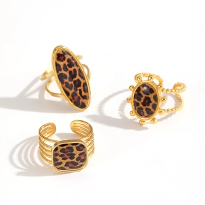 Adjustable leopard print rings in gold finish with oval, round, and square metal shapes