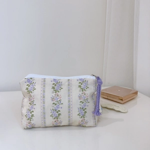 Floral cotton pouch featuring purple flower stripes and a decorative purple tassel detail