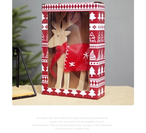 Detail of wooden Christmas reindeer with red scarf in a festive gift box