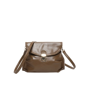 Deep brown leather crossbody bag with curved flap and gold metal clasp on white background