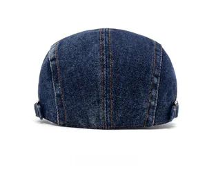 Rear view of washed denim flat cap featuring contrast yellow stitching and metal buckle