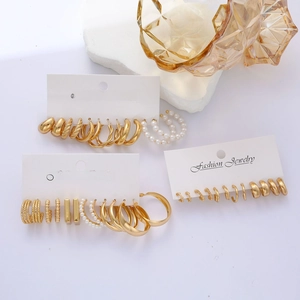 8-piece gold geometric earring set with pearls on display card with glass decor