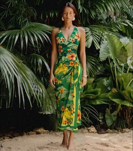 Detail of green tropical print wrap dress with V-neck and hibiscus floral patterns