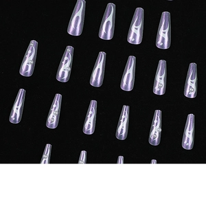 Long coffin fake nails with lavender aurora finish and silver flame patterns on black background