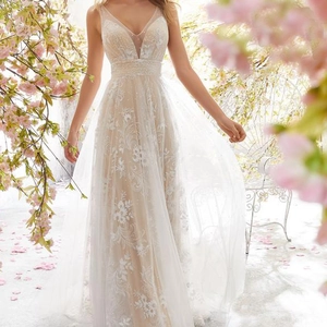 Elegant ivory V-neck sleeveless lace wedding dress with floral embroidery and pearl waist detail