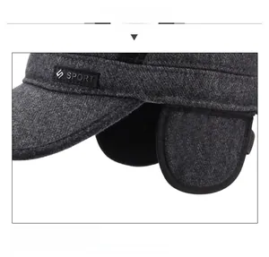 Detail of wool blend winter hat with ear flaps and black SPORT logo patch