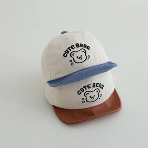Set of two cute bear baseball caps for babies with blue and brown brims in soft cotton
