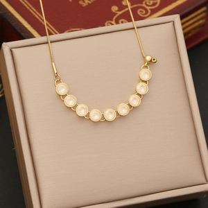 Detailed close-up of a gold zircon star necklace displayed in a beige premium jewelry box