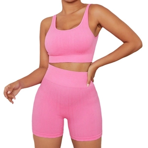 Pink seamless ribbed yoga set featuring a sports bra and high-waisted gym shorts
