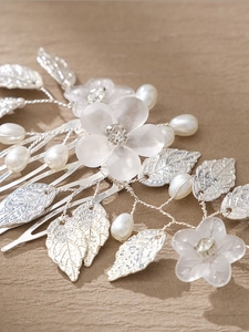 Detailed view of handmade silver floral hair comb with frosted petals and pearls