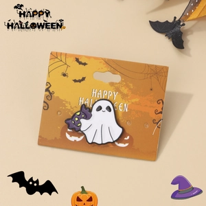 Detail of cute white ghost enamel pin on orange Happy Halloween card with festive props