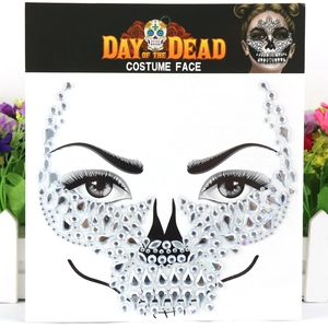 Detail view of Day of the Dead face jewels featuring silver acrylic rhinestones on packaging
