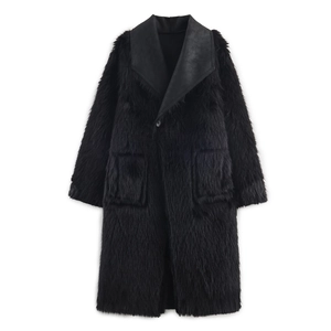 Detailed view of the black faux fur coat featuring a large lapel and soft texture