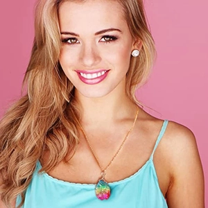 Detail of bohemian gold chain necklace with iridescent crystal pendant on a model