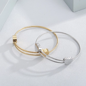 Set of two gold and silver heart pendant stainless steel cable wire bracelets for women