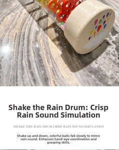 Detail of rainmaker percussion toy with colorful beads and natural wood finish