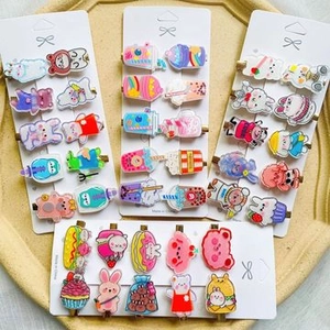 Close-up of cute acrylic hair clips with glitter, cartoon animals and food shapes