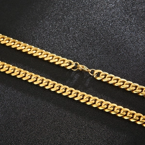Polished 18k gold plated 8mm Cuban link chain necklace displayed on a dark background