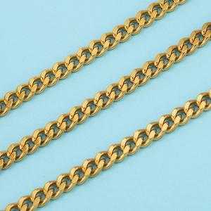 Polished gold-plated stainless steel Cuban link chain set against a sky blue background