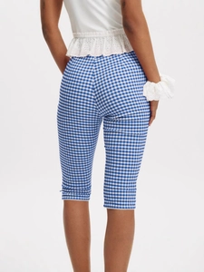 Women's blue plaid cropped pants with delicate white lace hem shown from behind