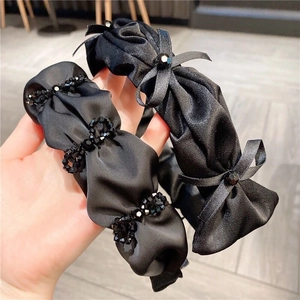 Elegant black pleated headband set with crystal beads and handmade satin ribbon bows
