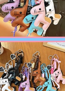 Cute leather horse bag charm keychain with braided rope and metal heart pendant accessory.