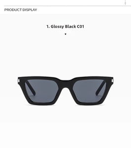 Close-up of black square sunglasses with distinctive silver rectangle corner accents