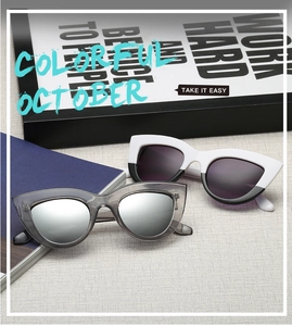 Detail view of vintage cat-eye sunglasses with silver mirrored and dark purple lenses