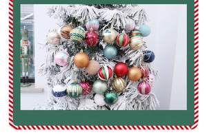 Close-up of colorful painted Christmas balls with glitter and matte finishes on a snowy tree