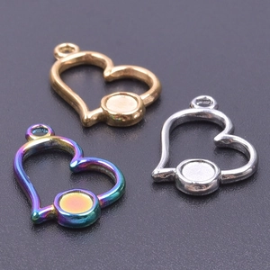 Three heart-shaped metal pendants in gold, silver, and rainbow finishes for DIY jewelry making
