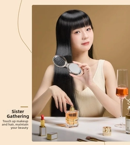 Close-up of portable silver folding hairbrush with integrated mirror in a social setting