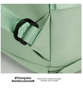 Detailed close-up of reinforced triangular stitching on the mint green fitness bag strap