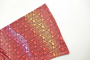 Macro shot of colorful geometric print fabric showing high-precision edge stitching quality
