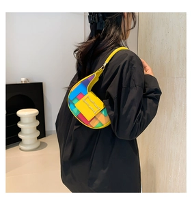Detail of a colorful geometric patchwork shoulder bag with vibrant leather texture