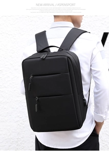 Detail of a black business backpack featuring waterproof fabric and USB charging port
