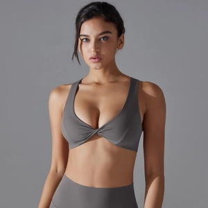 Detail of grey yoga bra featuring a stylish front knot design and high-stretch fabric