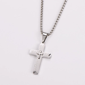 Detailed view of a silver stainless steel cross pendant with a sturdy box chain
