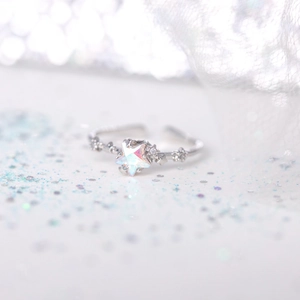 Close-up of adjustable star ring featuring an aurora gemstone and fine zircon accents