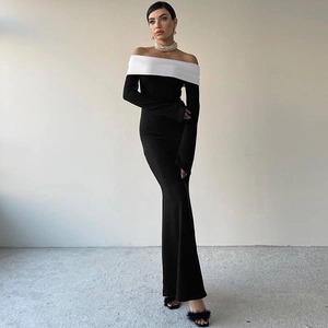 Detail of elegant off-the-shoulder contrast color fold and long sleeves on a black maxi dress
