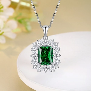 Elegant silver necklace featuring a rectangular emerald-cut green gemstone pendant