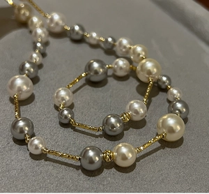 Macro detail of multi-colored pearls and gold metallic beads on a luxury necklace