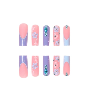 French tip press-on nails with 3D floral designs and blue rhinestones on long coffin shape