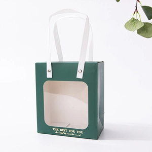 Detail of green premium gift bag with transparent window and gold printed text