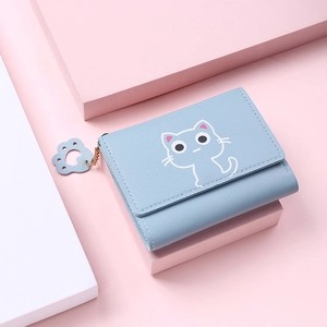Detail of light blue PU leather wallet with cartoon cat pattern and paw zipper charm