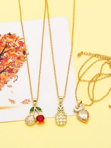 Detail of gold-plated necklaces with colorful zircon cherry and pineapple pendants