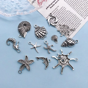 Detailed view of silver sea turtle and seahorse charms for DIY jewelry making