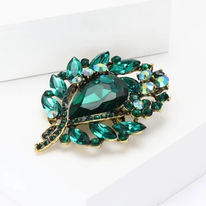 Elegant gold alloy brooch with emerald green rhinestones and a large water drop centerpiece