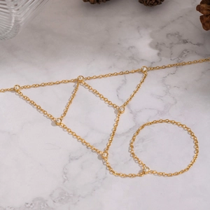 Detail of 18K gold plated mesh chain hand harness with sparkling zircon triangle pendant