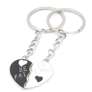 Pair of black and white heart-shaped Best Friends keychains in polished metal