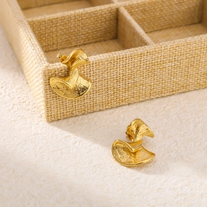 Textured irregular 18K gold plated stainless steel earrings on a beige jewelry box